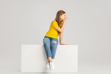 Image showing Happy kid, girl isolated on white studio background. Looks happy, cheerful, sincere. Copyspace. Childhood, education, emotions concept