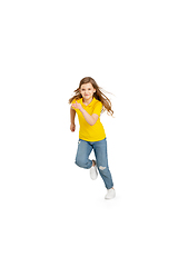 Image showing Happy kid, girl isolated on white studio background. Looks happy, cheerful, sincere. Copyspace. Childhood, education, emotions concept