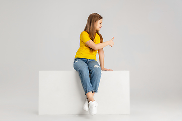 Image showing Happy kid, girl isolated on white studio background. Looks happy, cheerful, sincere. Copyspace. Childhood, education, emotions concept