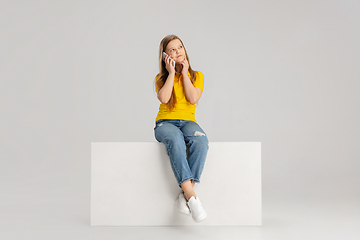 Image showing Happy kid, girl isolated on white studio background. Looks happy, cheerful, sincere. Copyspace. Childhood, education, emotions concept