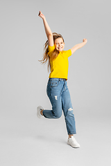 Image showing Happy kid, girl isolated on white studio background. Looks happy, cheerful, sincere. Copyspace. Childhood, education, emotions concept