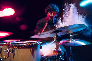 Image showing Drummer\'s rehearsing on drums before rock concert. Man recording music on drumset in studio