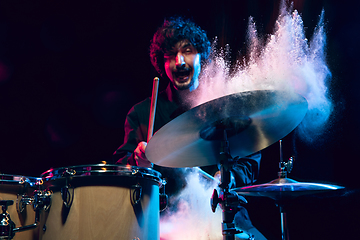 Image showing Drummer\'s rehearsing on drums before rock concert. Man recording music on drumset in studio