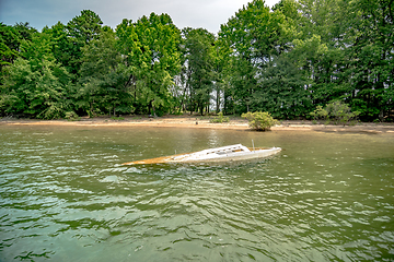 Image showing dirty sunken boat floating in the lake