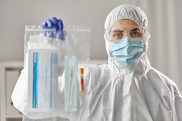 Image showing doctor in protective wear with medical test sample