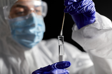 Image showing scientist holding beaker with coronavirus test