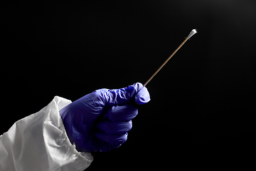 Image showing doctor's hand in medical glove holding cotton swab