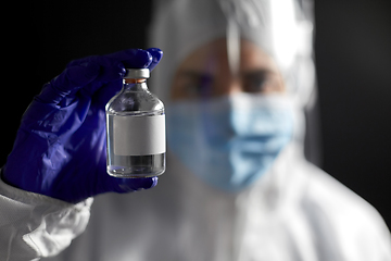 Image showing close up of doctor's hand with bottle of medicine