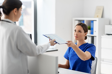 Image showing doctor and nurse with clipboard at hospital