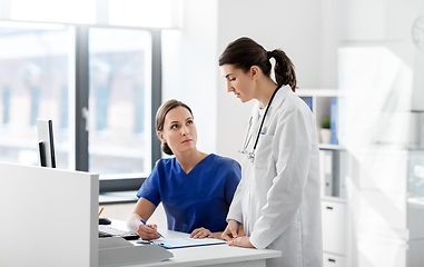 Image showing doctor and nurse with clipboard at hospital