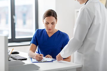 Image showing doctor and nurse with clipboard at hospital