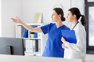 Image showing nurse showing something to doctor at hospital