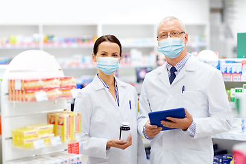 Image showing apothecaries in masks with tablet pc at pharmacy