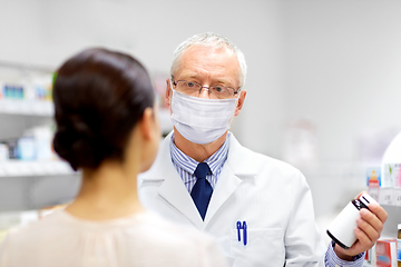 Image showing apothecary in mask showing drug to customer