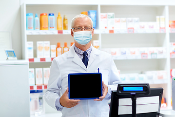 Image showing old apothecary in mask with tablet pc at pharmacy