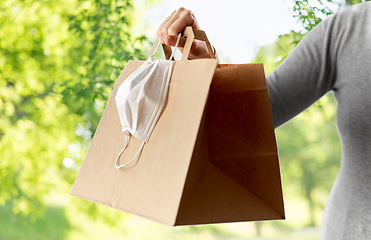 Image showing woman with shopping bag, face mask and gloves