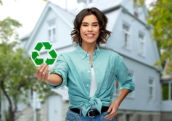 Image showing smiling young woman holding green recycling sign