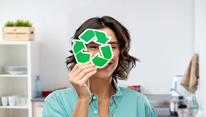 Image showing smiling woman looking through green recycling sign