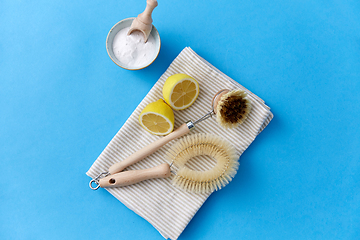 Image showing cleaning brushes, lemon and washing soda on cloth