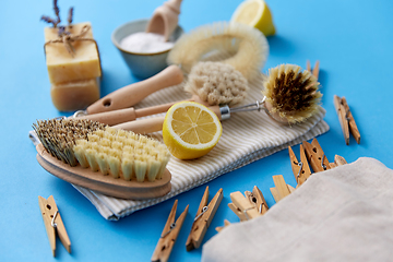 Image showing cleaning brushes, lemon and wooden clothespins