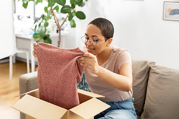 Image showing african american woman opening parcel box at home