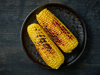 Image showing grilled corn on black plate