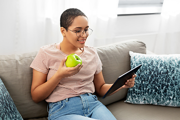 Image showing african woman with tablet pc and apple at home