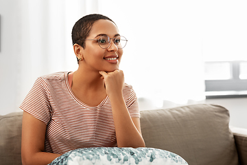 Image showing african american woman in glasses sitting on sofa