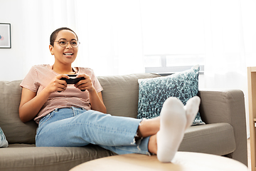 Image showing african american woman with gamepad playing game