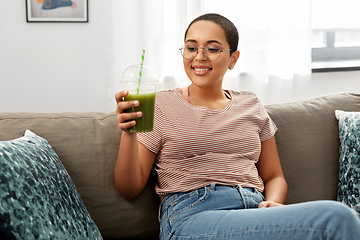 Image showing african american woman drinking smoothie at home