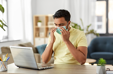 Image showing indian man in mask with laptop at home office