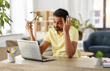 Image showing stressed man with laptop working at home office