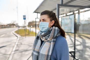 Image showing young woman wearing medical mask at bus stop