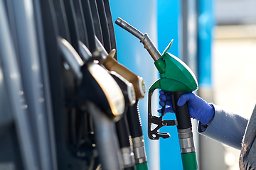 Image showing close up of hand in glove with gas nozzle