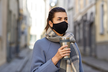 Image showing woman in reusable mask with tumbler in city