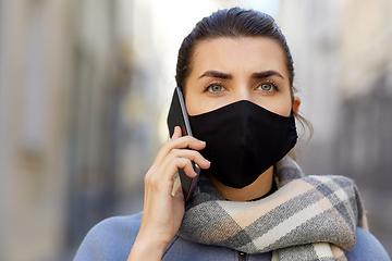 Image showing woman in protective reusable mask calling on phone