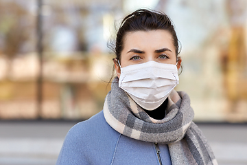 Image showing young woman wearing protective medical mask