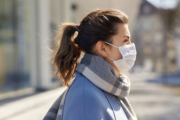 Image showing young woman wearing protective medical mask