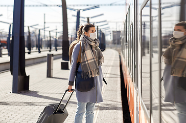 Image showing woman in protective face mask at railway station