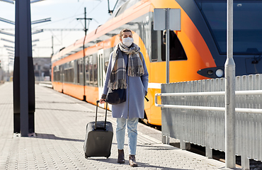 Image showing woman in protective face mask at railway station