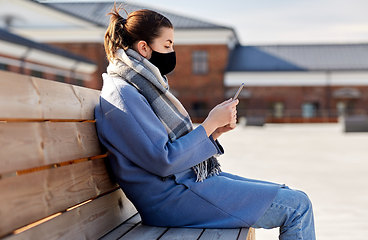 Image showing woman in face mask with smartphone in city