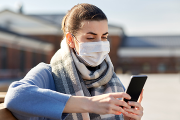 Image showing woman in face mask with smartphone in city