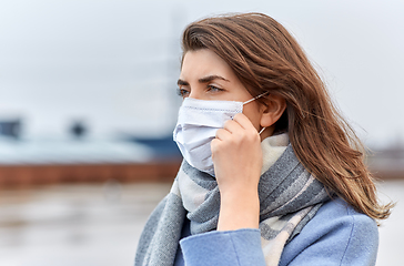 Image showing young woman wearing protective medical mask