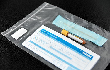 Image showing beaker with test, cotton swab and medical report