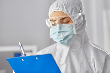 Image showing doctor in medical mask and goggles with clipboard