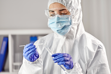 Image showing scientist holding beaker with coronavirus test