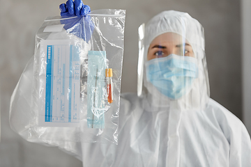 Image showing doctor in protective wear with medical test sample