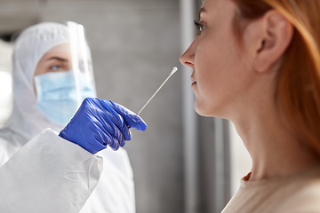 Image showing doctor in protective wear making coronavirus test