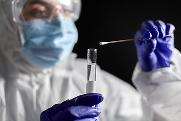 Image showing scientist holding beaker with coronavirus test