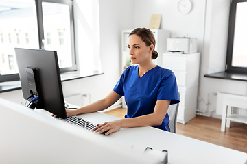 Image showing doctor or nurse with computer working at hospital